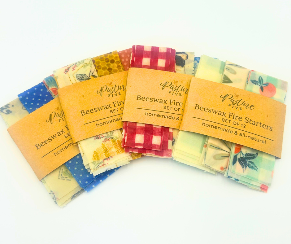 Set of beewax fire starters with colorful packaging on a white background