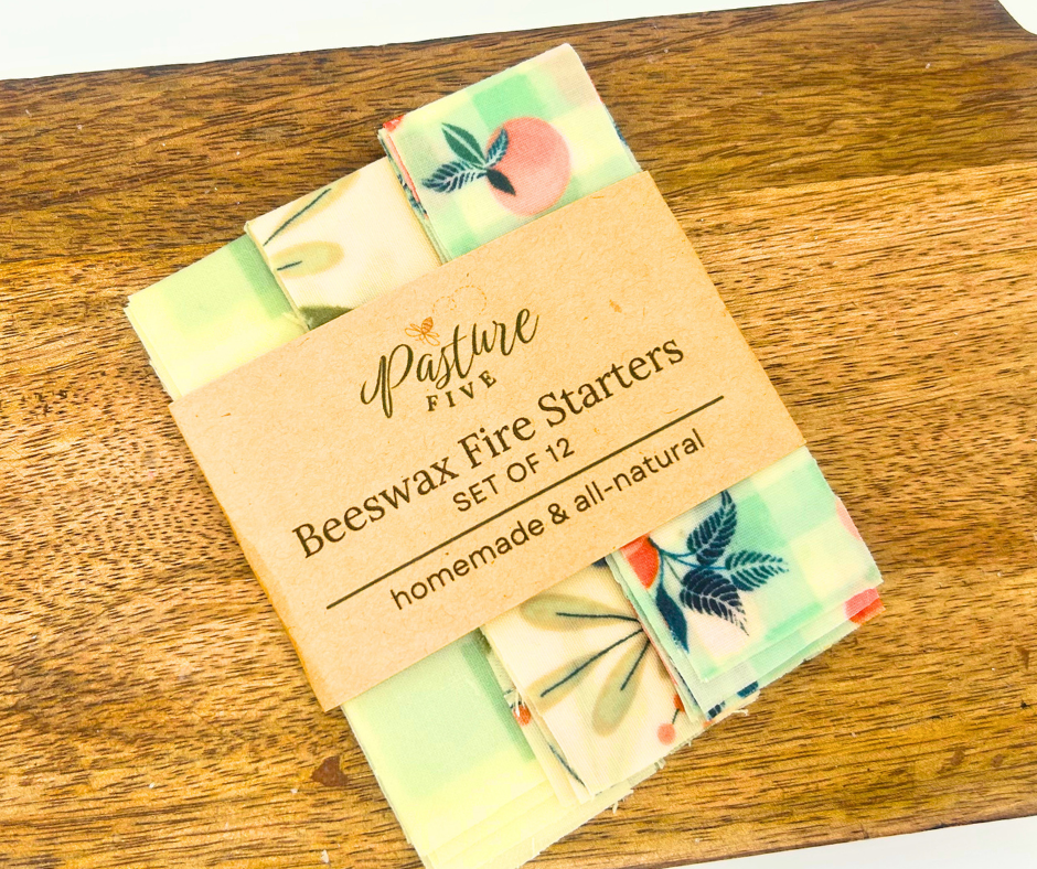 Set of beeswax fire starters with a Pasture Five label on a wooden surface
