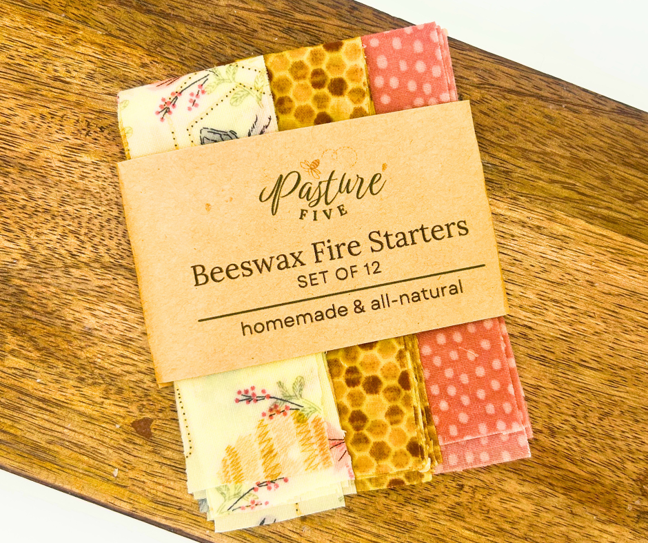Set of 12 beeswax fire starters with a brown Pasture Five label on a wooden surface.