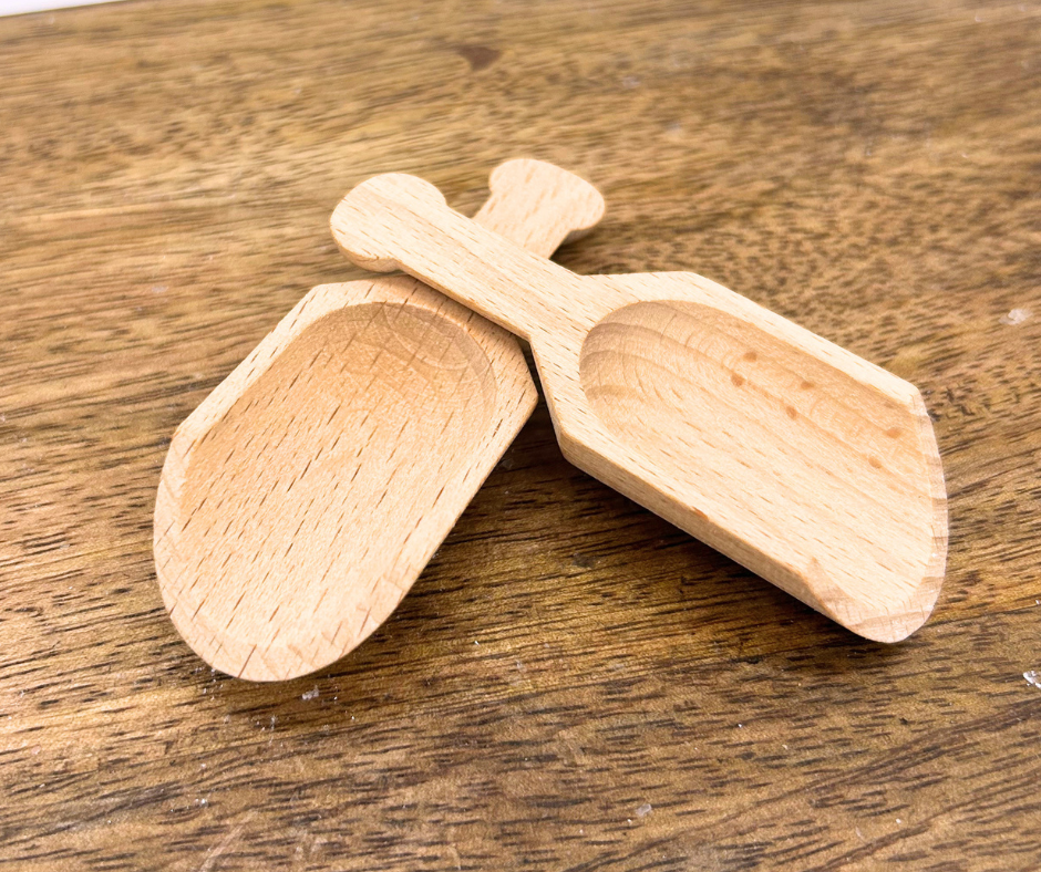 Two wooden spoons on a wooden surface