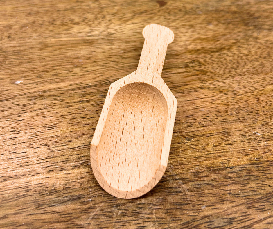 Small wooden scoop on a wooden surface