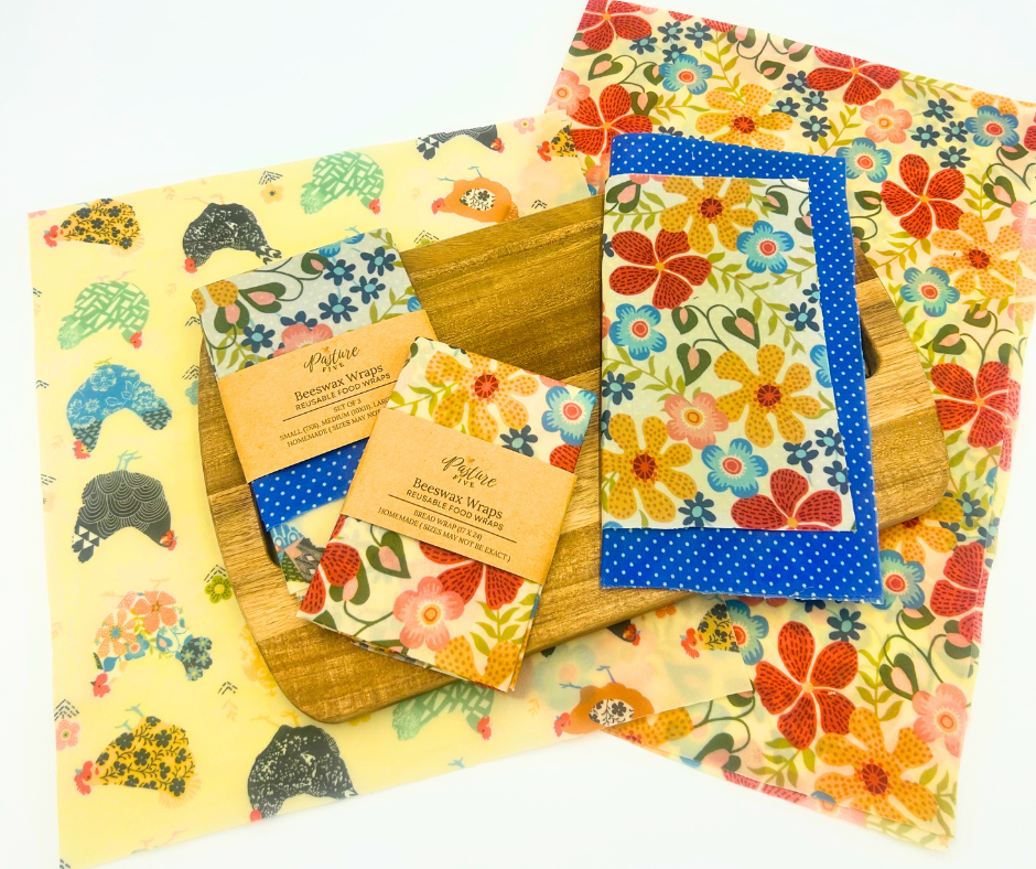 Set of reusable wax wraps with colorful floral and polka dot patterns on a white background.