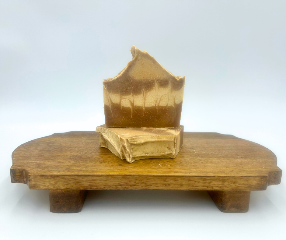 Rustic Sandalwood Goat milk soap on a wooden stand a white background