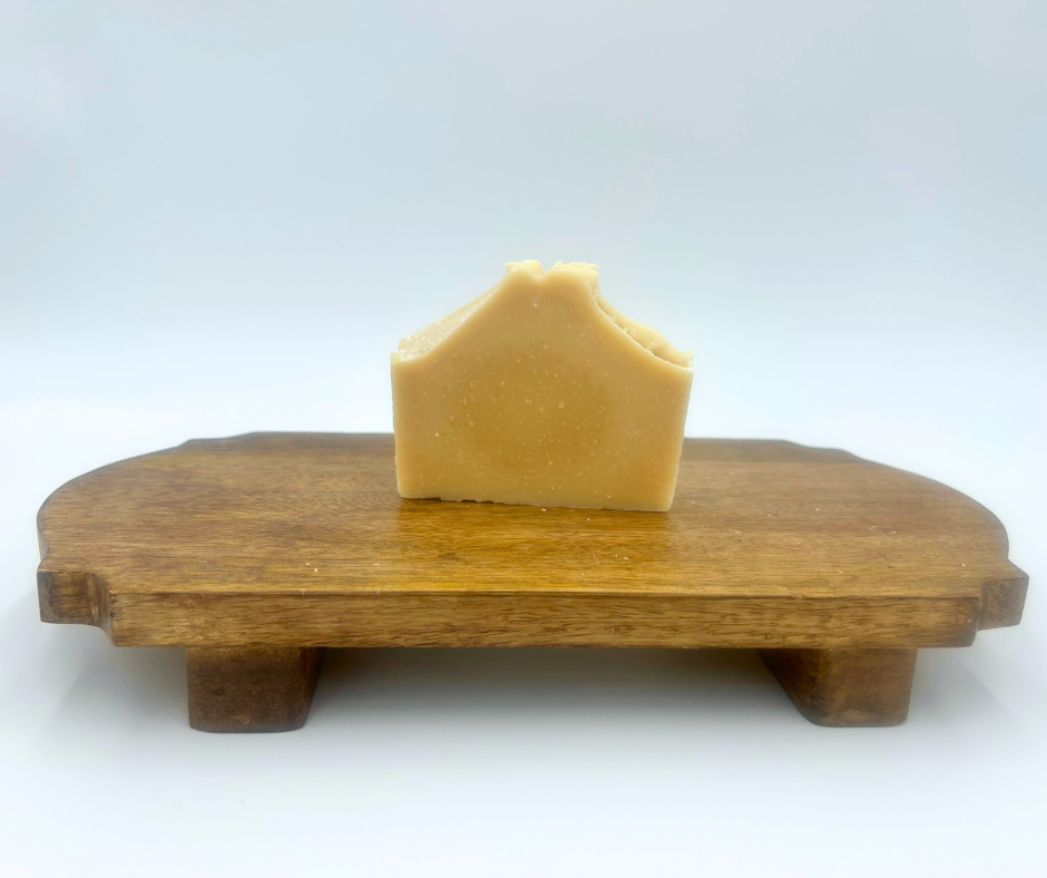 goat milk soap on a wooden stand with a white background