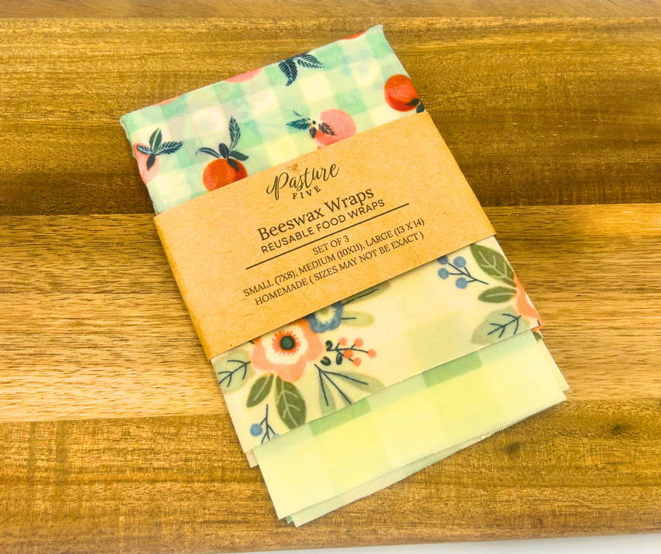 Set of reusable food wraps with floral design on a wooden surface