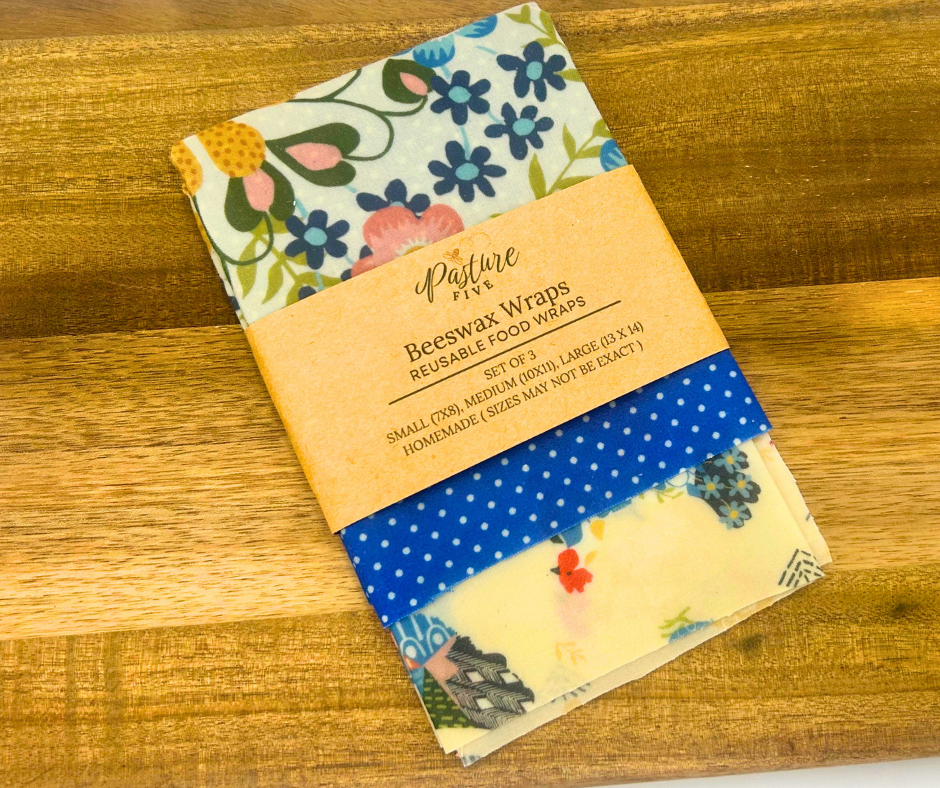 Set of beeswax wraps with floral and polka dot patterns on a wooden surface