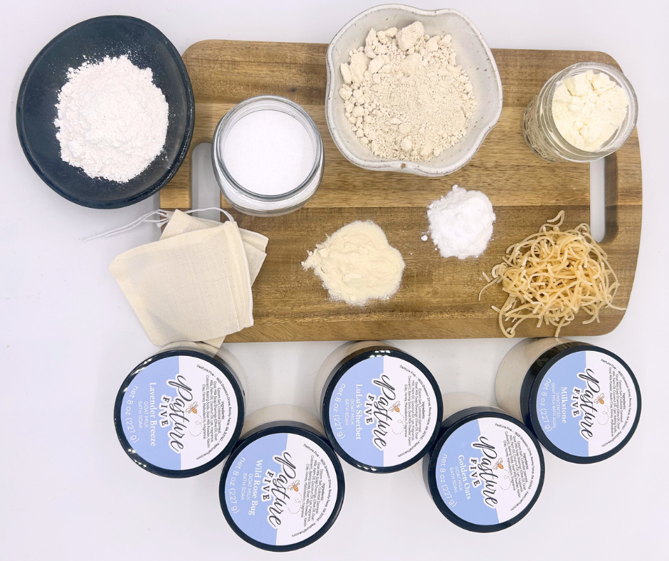Wooden cutting board with various ingredients and bath soaks on a white background.
