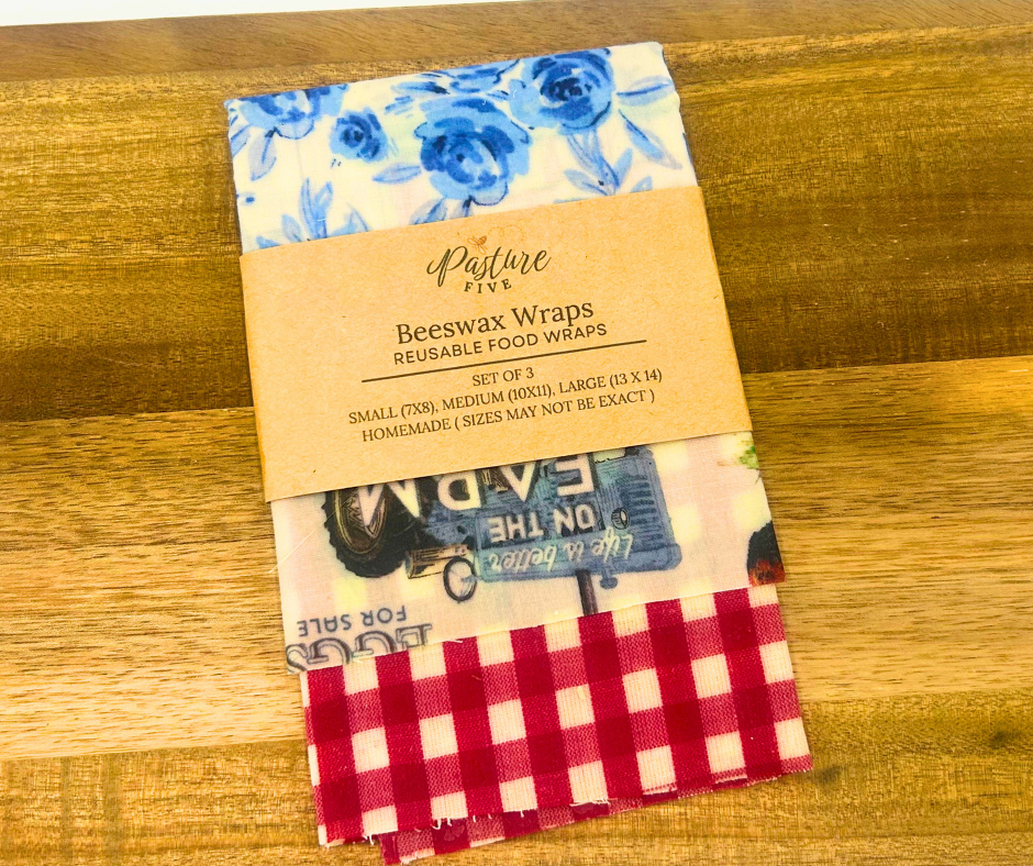 Set of reusable food wraps with a label on a wooden surface