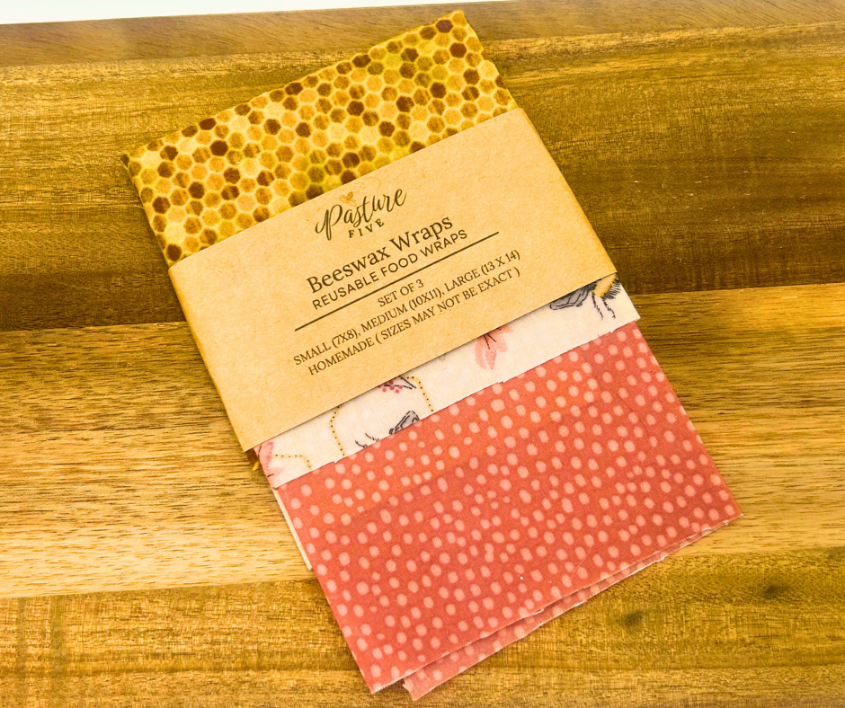 Set of beeswax wraps with a Pasture Five package on a wooden surface