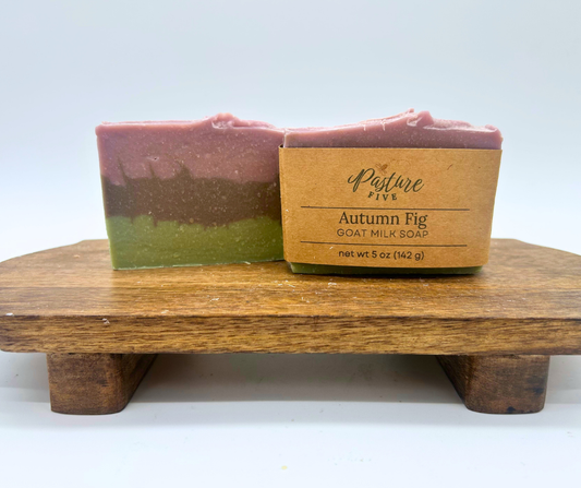 2 Full bars of Autumn Fig. One with a wrap on a wood board. 