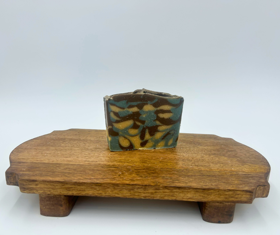 Blue Harvest Soap on a wooden stand against a white background