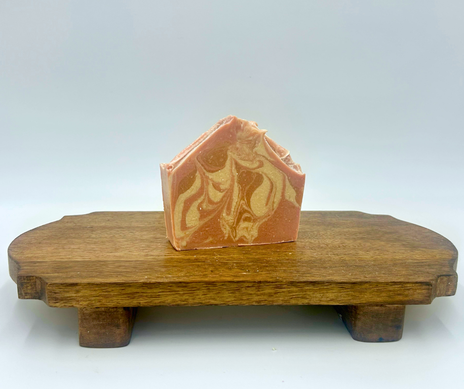 Marbled soap bar on a wooden stand with a white background