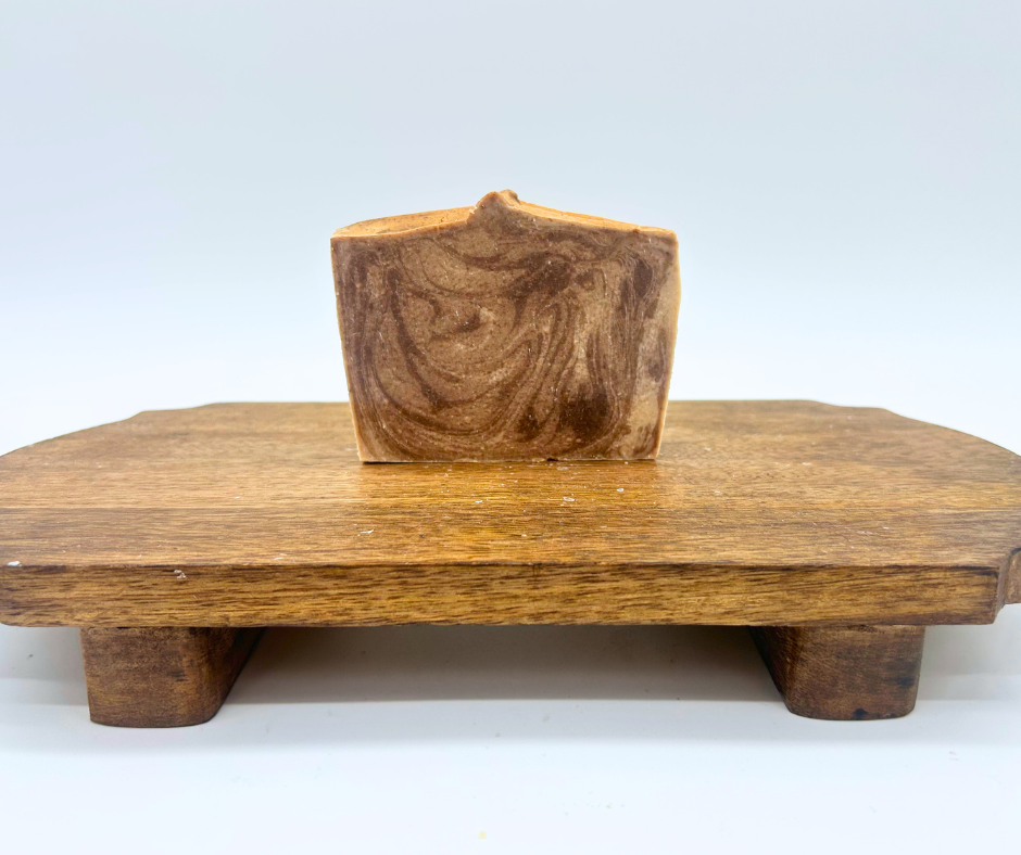 one bars of Cashmere & Cocoa on a wood board. 
