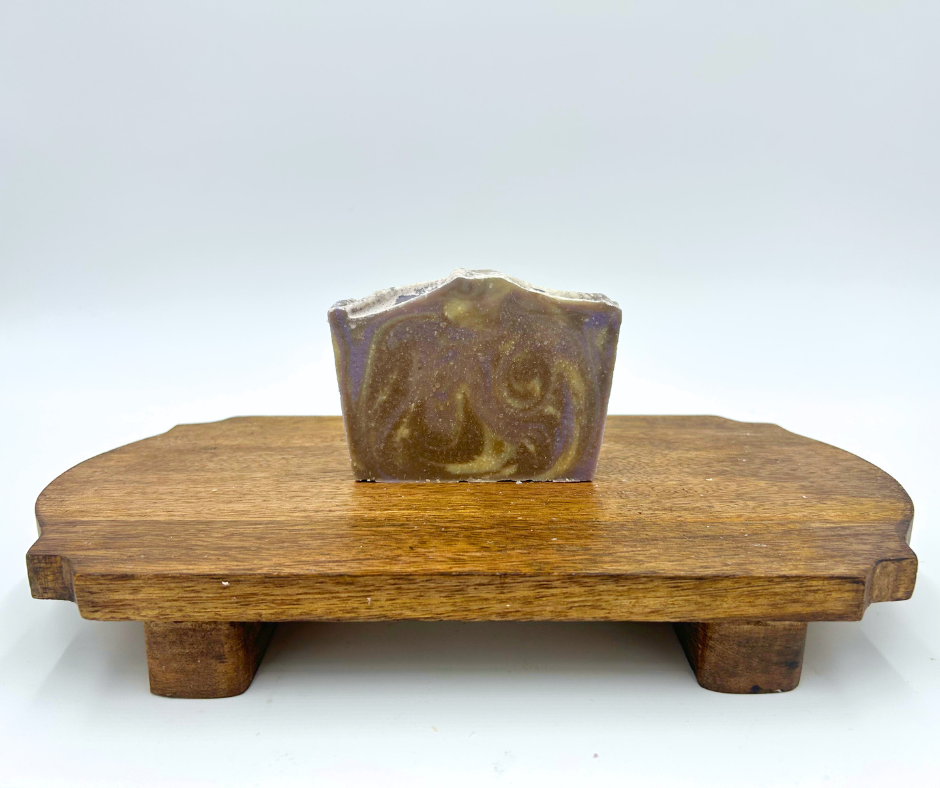 One Soap on a brown platform. Cedar Lavender, purple, brown, and Cream. 