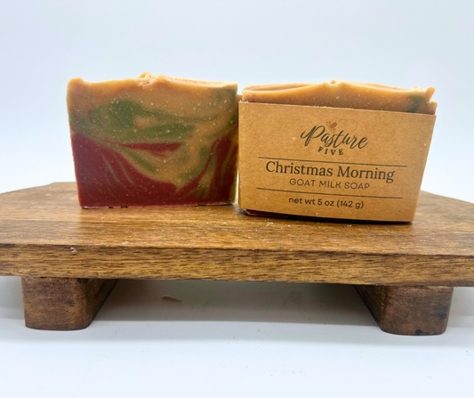 Two bars of Christmas Morning Goat Milk Soaps. One with a wrap and one with none. 