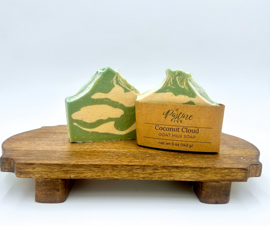 Two blue and white soap bars on a wooden stand with a white background