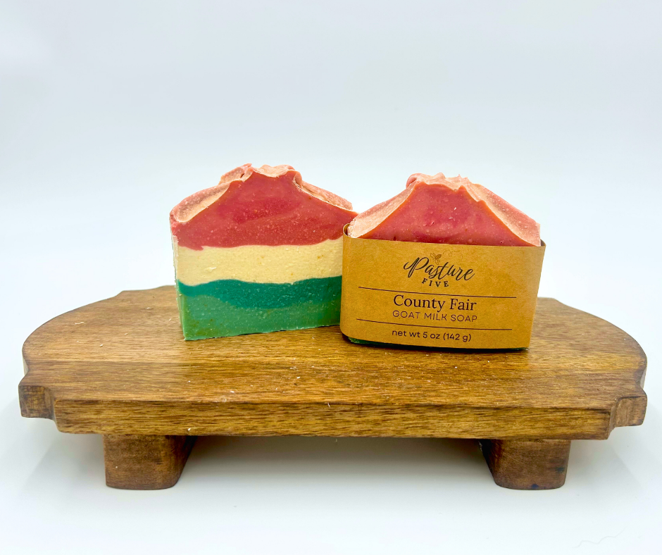 Two layered soap on a wooden stand with a white background