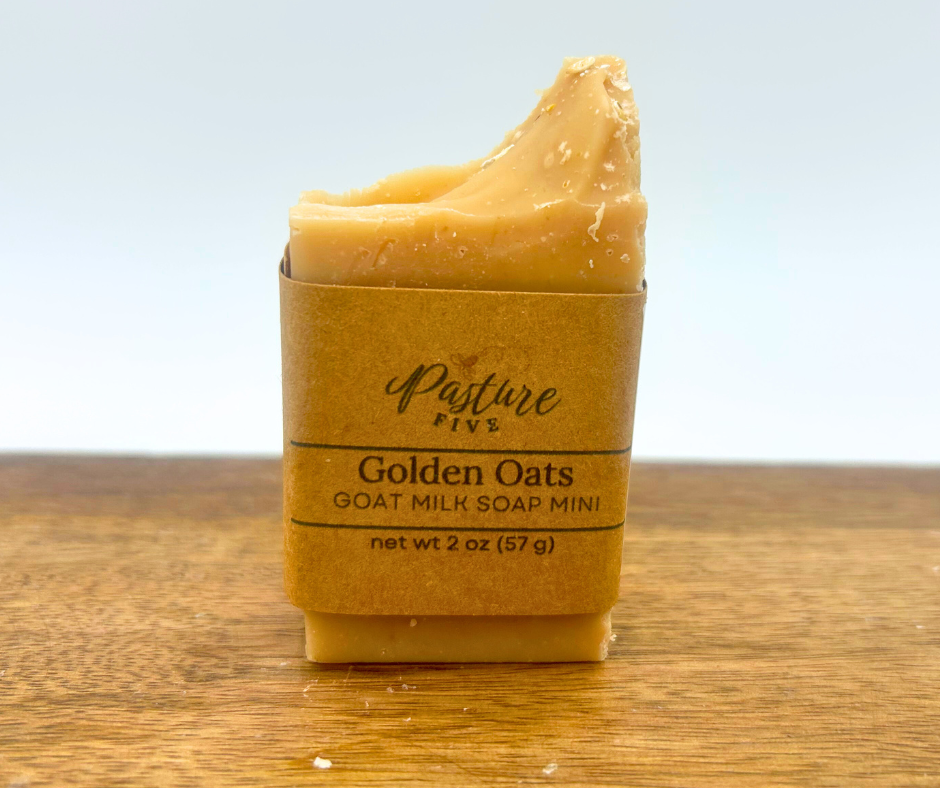 Mini Goat milk soap bar in a brown paper packaging with 'Pasture' branding on a wooden surface.