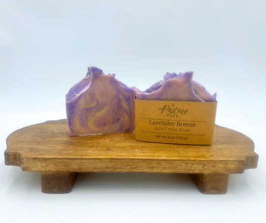 Two bars of lavender soap on a wooden stand with a Pasture Five label.