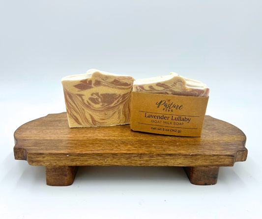 Two Soaps on a brown platform. Lavender Lullaby, purple and white swirl. 