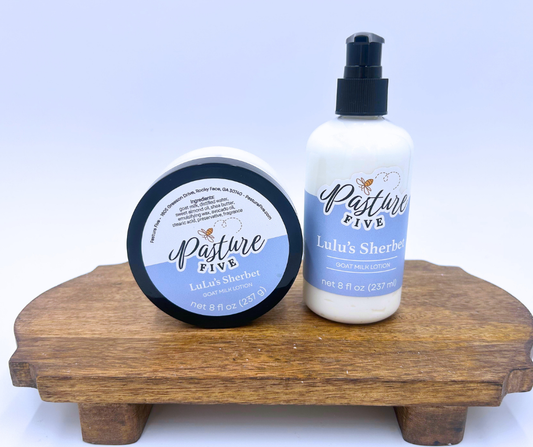 Two jars of Lulu's Sherbet Lotion from Pasture Five on a wooden stand with a white background