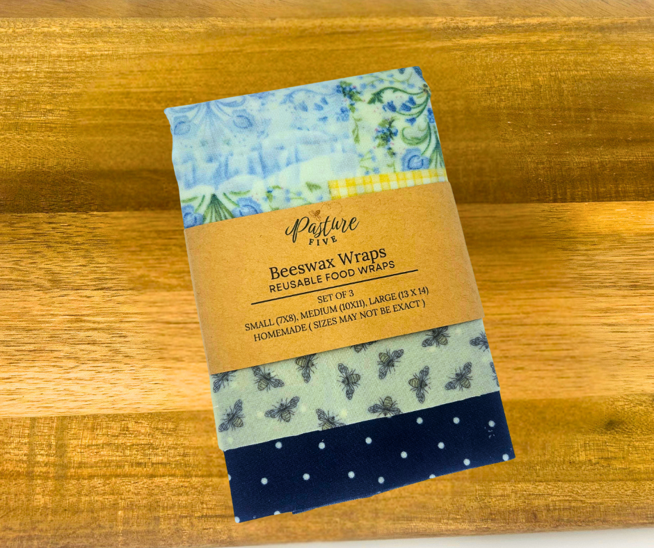 Set of beeswax wraps with a branded label on a wooden surface