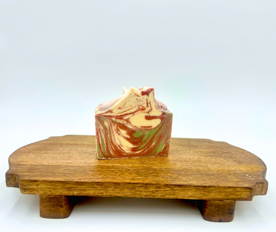 Swirled soap on a wooden stand with a white background