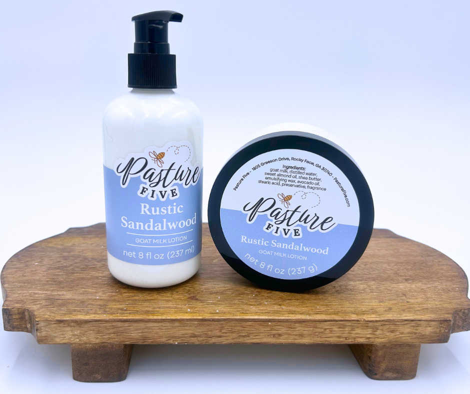 Two bottles of 'Pasture Five Rustic Sandalwood' on a wooden stand with a white background