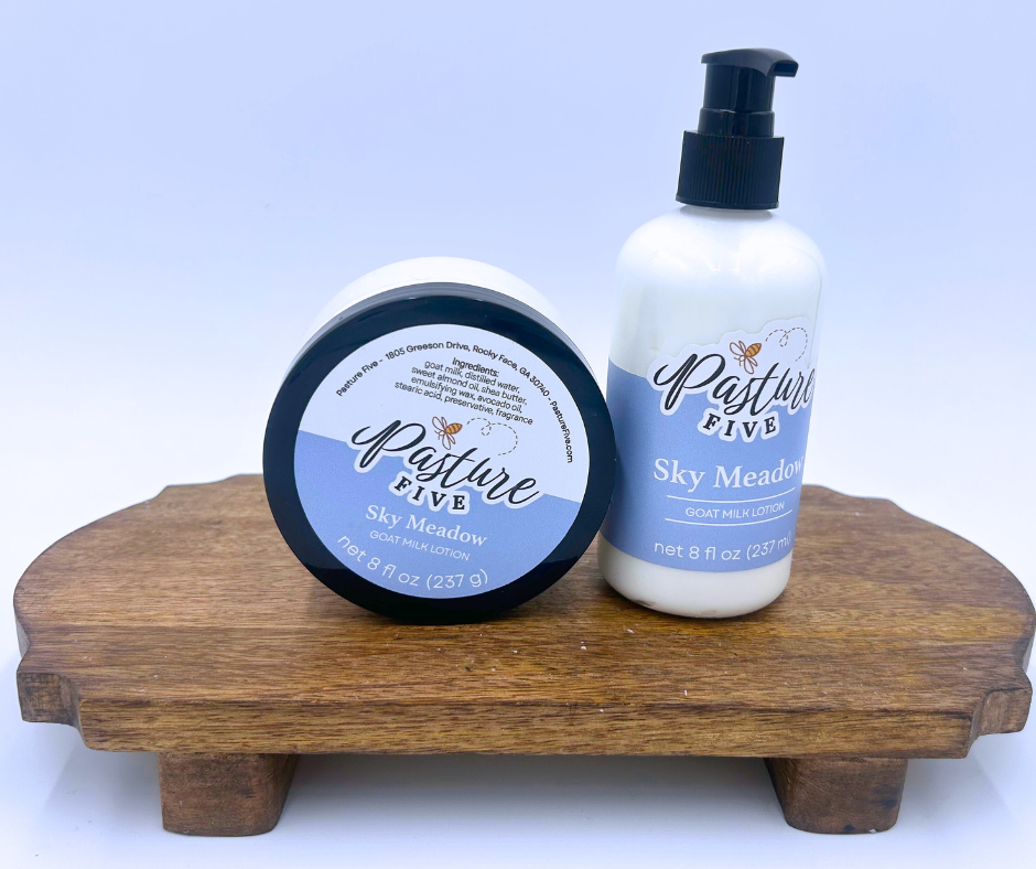 Two bottles of 'Pasture Five Sky Meadow' on a wooden stand with a light blue background