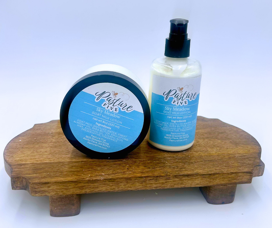 Two bottles of Sky Medow lotion on a wooden stand with a white background