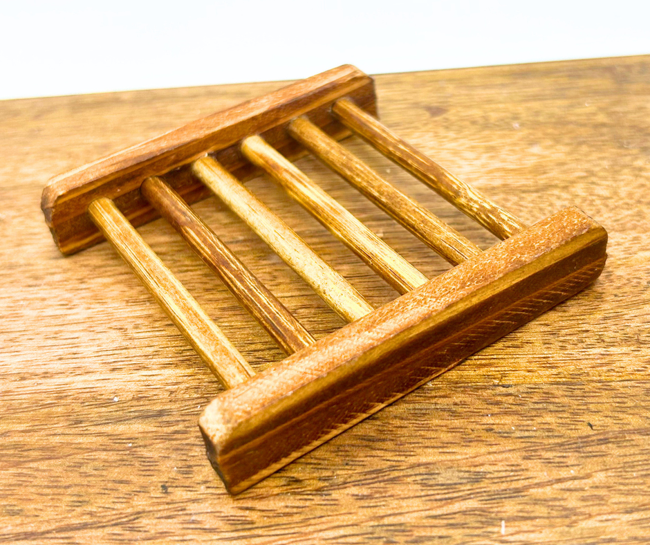 Wooden soap dish on a wooden surface