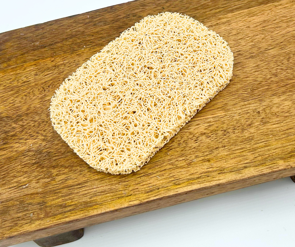 A soap saver pad on a wooden board with a white background