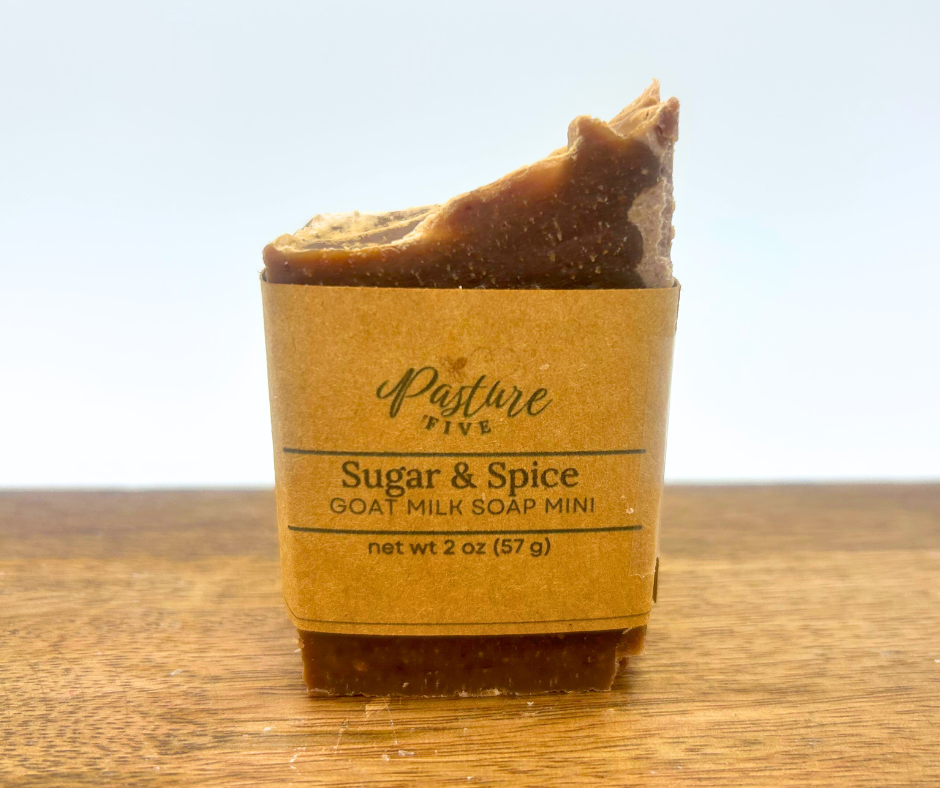 Mini Sugar & Spice Goat Milk Soap Bar on a brown surface. 