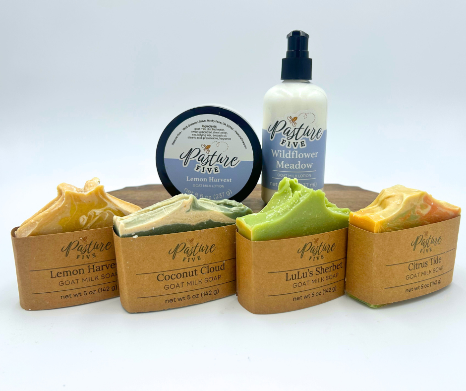 Collection of Pasture Fixe skincare products including soaps and a bottle on a white background