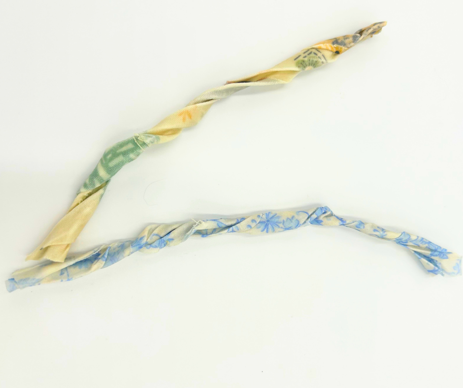 Two twisted floral-patterned fire starters on a white background