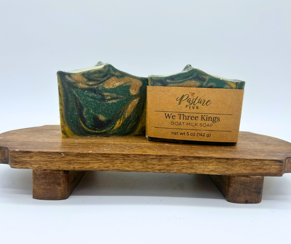 Two bars of We Three Kings Goat Milk Soaps. One with a wrap and one with none. 