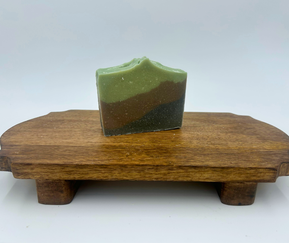 Three-layered soap on a wooden stand with a white background