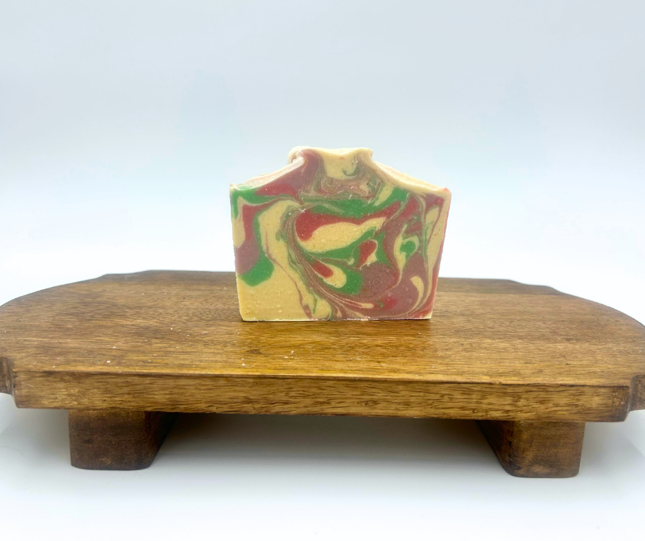 Wildflower Meadow Colorful  Goat Milk soap bar with marbled pattern on a wooden stand against a white background