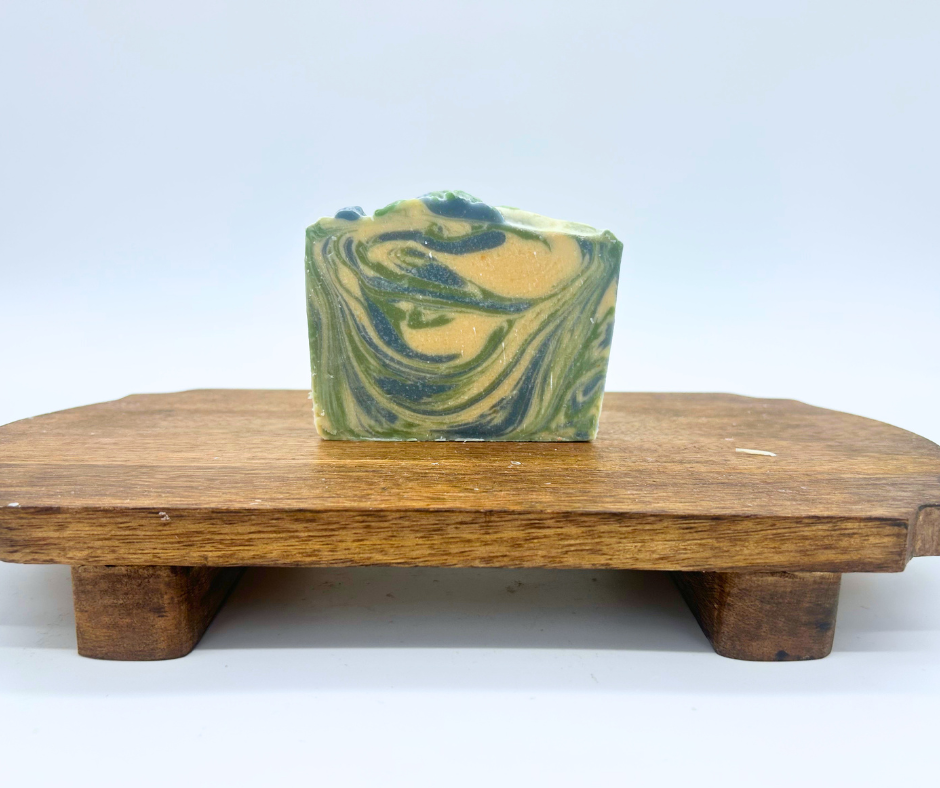 One Winterberry Goat Milk Soap on a wood board. 