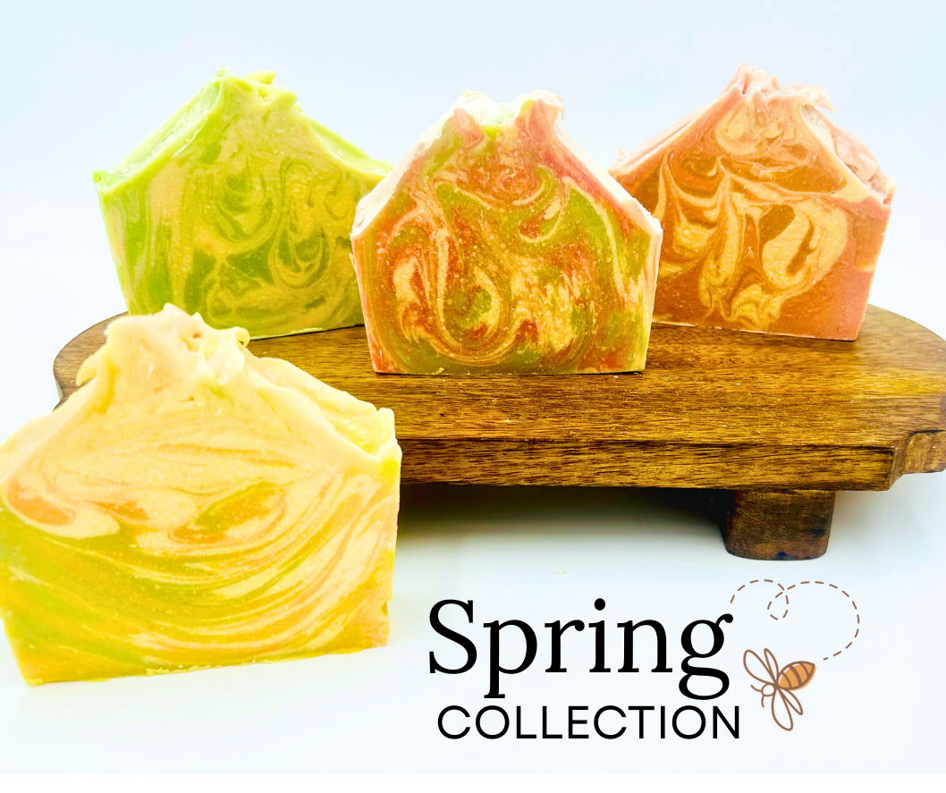 Four colorful soap bars on a wooden stand with 'Spring Collection' text and logo.
